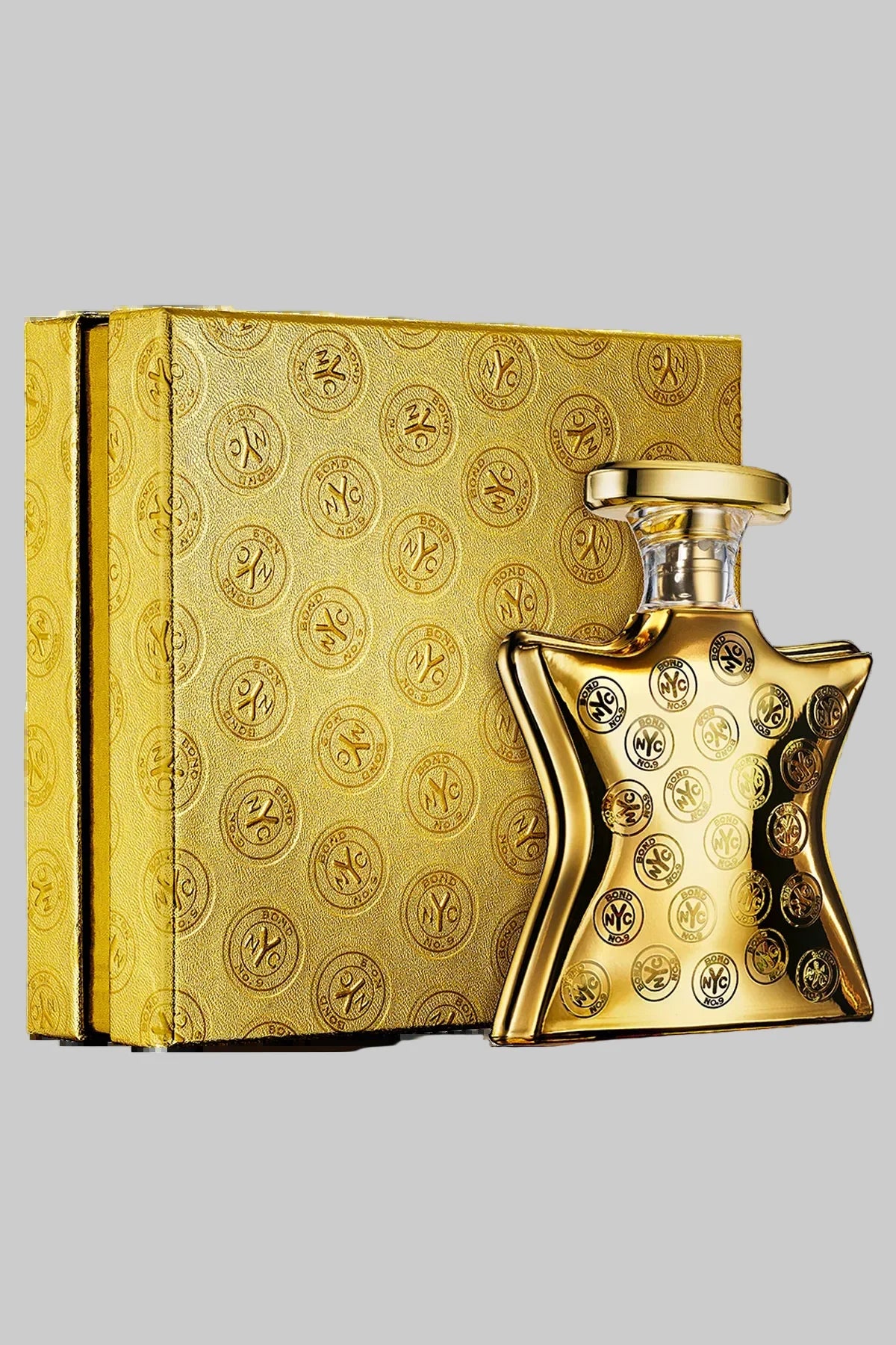 Gold perfume bottle and packaging with intricate design on a white background